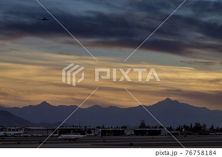 Silhouette of runway signs during sunset the sky red clouds the airport during takeoff of the plane Silhouette of runway signs during sunset the sky red clouds the airport during takeoff of the plane 76758184