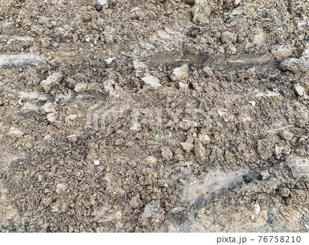 Brown loose fertile soil with sand and cracks. The background. Texture Brown loose fertile soil with sand and cracks. The background. Texture 76758210