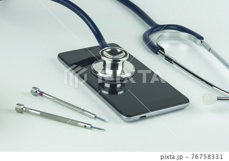 Stethoscope, smartphone and screwdrivers. 76758331