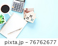 Business, finance , savings money, property loan or mortgage concept : Top view, flat lay of wood house model, gift box, blank notebook, calculator and coffee on table, ready for adding or mock up 76762677