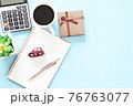Business, finance, saving money or car loan concept : Top view or flat lay of miniature car model on blank notebook paper, gift box, calculator and coffee on table, ready for adding or mock up 76763077