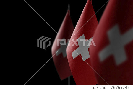 Small national flags of the Switzerland on a black background 76765245