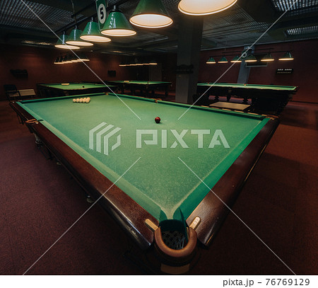Billiard table with green surface and balls in the billiard club.Pool Game 76769129