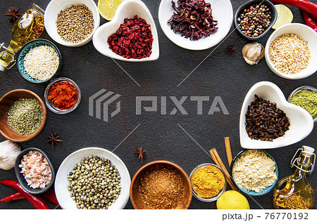 Various spices in a bowls on a black 76770192