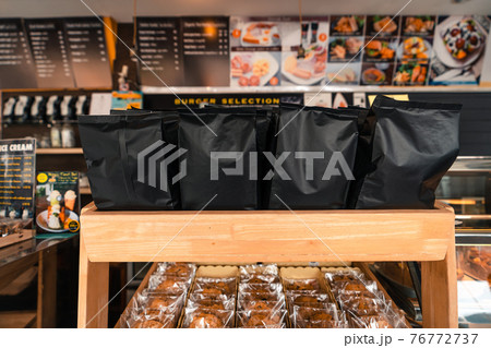 Black coffee bags on the shelves sold in the coffee shop. Black coffee bags on the shelves sold in the coffee shop. 76772737