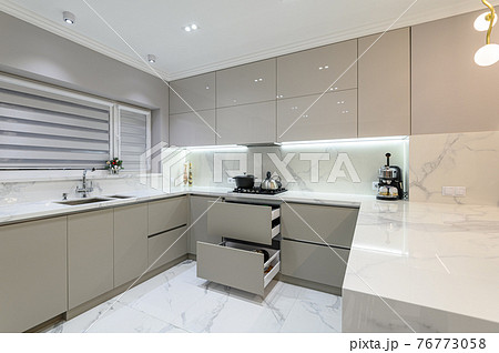 Open drawers at modern white kitchen furniture Open drawers at modern white kitchen furniture 76773058
