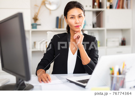 Portrait of successful business woman in office interior 76774364