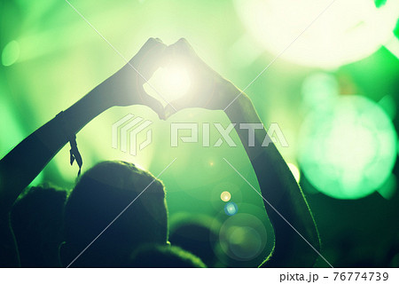 Crowd at a music concert, audience raising hands up 76774739