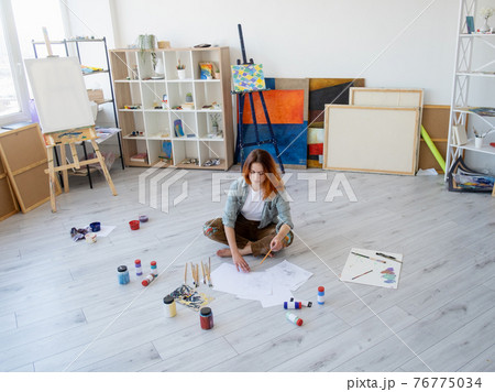 painting art artist woman drawing in light studio 76775034