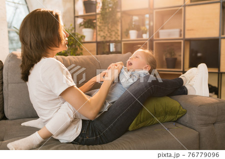 Family time. Mother and daughter having time together at home, look happy and sincere Family time. Mother and daughter having time together at home, look happy and sincere 76779096