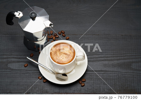 Cup of espresso coffee and mocha coffee maker on dark wooden background 76779100