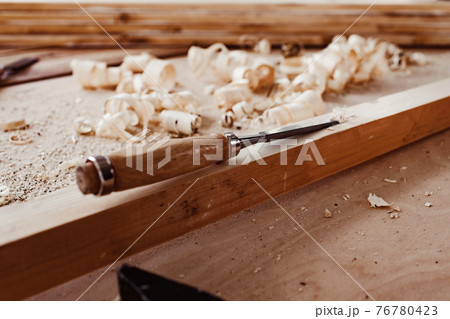 Carpenter's chisel, woodwork tool on the desktop in the workshop 76780423