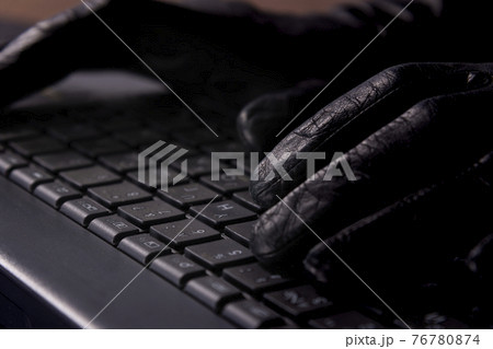 Hacker's hands on laptop keyboard. Hacking a security system. Hacker in gloves 76780874