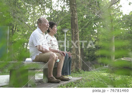 Senior couple sitting on bench in the park. Senior couple sitting on bench in the park. 76781460