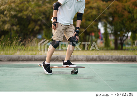 Hello Summer Surfers people Asian having fun with surfboards or surf skate around city streets background on a summer day. Free relax lifestyle and millennial trend concept 76782509