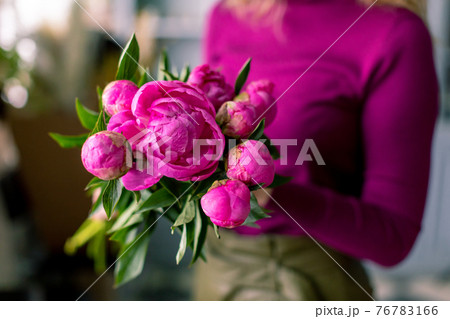 Close-up flowers in hand. Florist workplace. Woman arranging a bouquet with roses, chrysanthemum, carnation and other flowers. A teacher of floristry in master classes or courses Close-up flowers in hand. Florist workplace. Woman arranging a bouquet with roses, chrysanthemum, carnation and other flowers. A teacher of floristry in master classes or courses 76783166