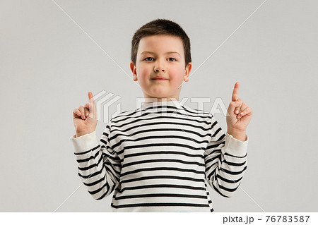 Caucasian boy isolated on white studio background. Copyspace. Childhood, education, emotions concept 76783587