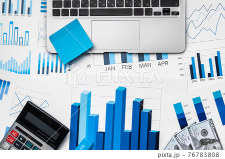 Financial paper with charts and diagrams on gray table 76783808