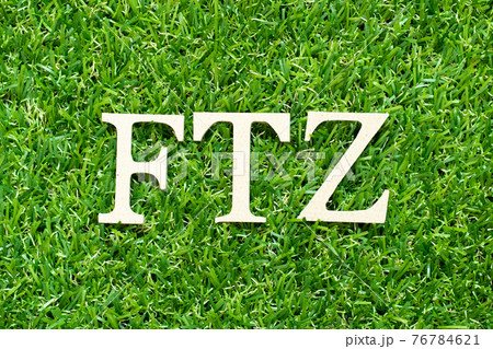Alphabet letter in word FTZ (Abbreviation of Free trade zone) on green grass background 76784621