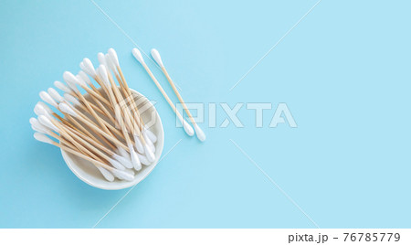 Bamboo cotton swabs or sticks top view on blue background Bamboo cotton swabs or sticks top view on blue background 76785779