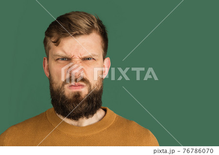 Caucasian man's portrait isolated over green studio background with copyspace Caucasian man's portrait isolated over green studio background with copyspace 76786070