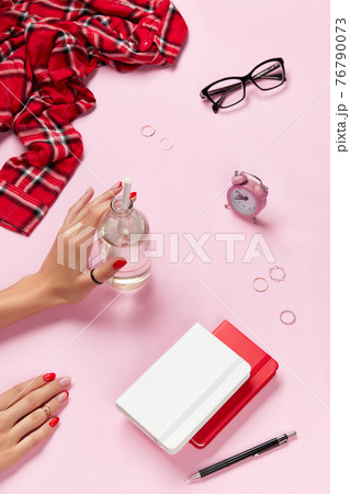 Creative composition with womans hands, planner end accessories over pink table 76790073