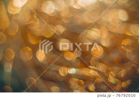 Golden streamers with sparkling glitter. Christmas holidays background 76792010