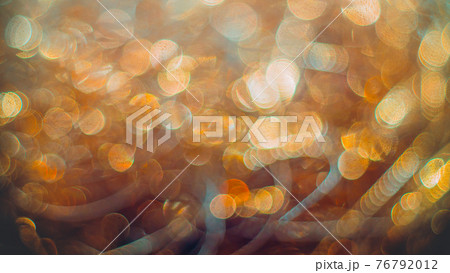 Golden streamers with sparkling glitter. Christmas holidays background 76792012