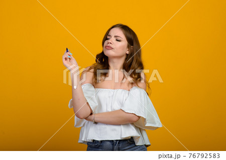 Cheerful young female in formal wear holding pen and smiling Cheerful young female in formal wear holding pen and smiling 76792583