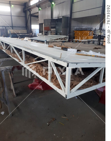Metal welded steel frame made of pipes of a block-modular building of a transformer substation. Insulation of the roof of a sandwich panel with mineral wool Metal welded steel frame made of pipes of a block-modular building of a transformer substation. Insulation of the roof of a sandwich panel with mineral wool 76793092