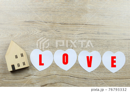 Paper heart shape and wooden house and have copy space. Paper heart shape and wooden house and have copy space. 76793332