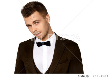 Muscle strong beautiful stripped male model in toxedo and trousers on white isolated font background Muscle strong beautiful stripped male model in toxedo and trousers on white isolated font background 76794083