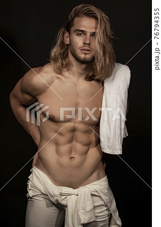 Sexy sport muscle strongface blond guy with long hair in white underwear on black isolated font background Sexy sport muscle strongface blond guy with long hair in white underwear on black isolated font background 76794355