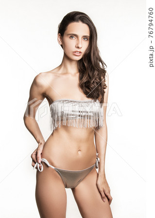 Stunning beautiful dark hair girl stripped in lingerie on white isolated font background Stunning beautiful dark hair girl stripped in lingerie on white isolated font background 76794760