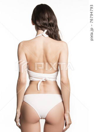 Stunning beautiful dark hair girl stripped in lingerie on white isolated font background 76794793
