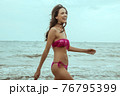 Stunning beautiful dark hair girl stripped in swimsuit on the sunset at he beach 76795399