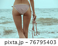 Stunning beautiful dark hair girl stripped in swimsuit on the sunset at he beach 76795403