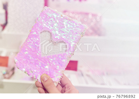 Notebook with anti-stress sequin cover in woman hand. Notebook with anti-stress sequin cover in woman hand. 76796892