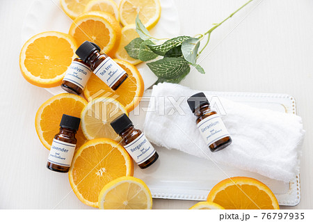 アロマオイルの瓶とフルーツ（オレンジとレモン） 76797935