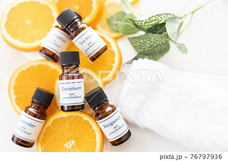 アロマオイルの瓶とフルーツ（オレンジとレモン） 76797936