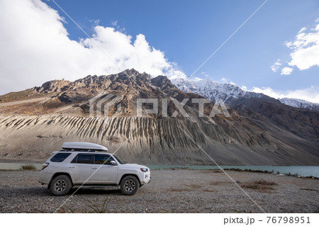 Driving off road car on high altitude mountains 76798951