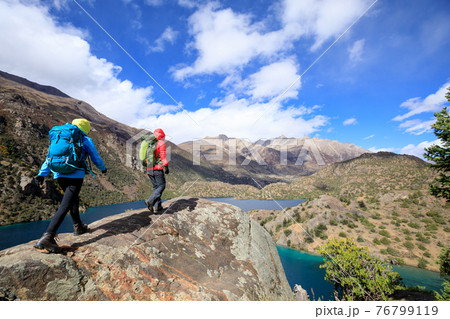 Two women backpackers hiking  in beautiful winter mountains 76799119