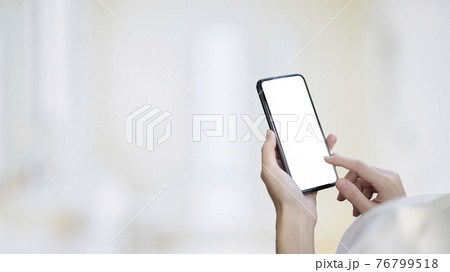 Over shoulder close up view of female hands holding and touching on mock up smartphone screen 76799518