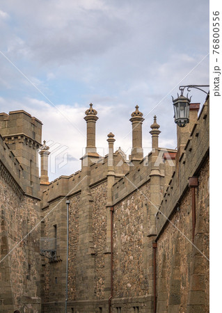 The walls and towers of the old palace on the background of a cloudy sky 76800556