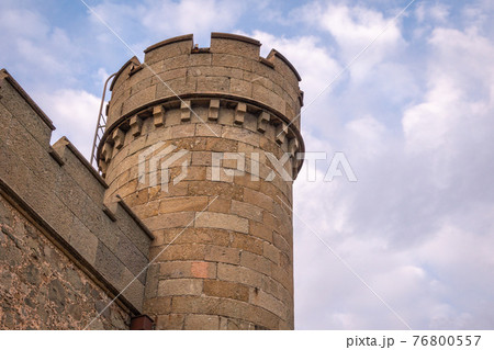 The walls and towers of the old palace on the background of a cloudy sky The walls and towers of the old palace on the background of a cloudy sky 76800557