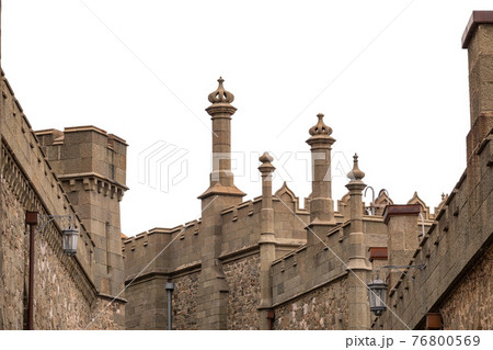 The walls and towers of the old palace on the background of a cloudy sky 76800569