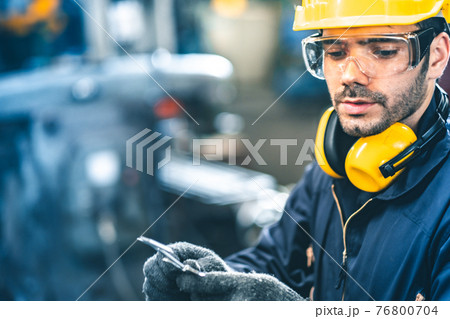 Industrial Engineers in Hard Hats.Work at the Heavy Industry Manufacturing Factory.industrial worker indoors in factory. man working in an industrial factory.Safety first concept. 76800704