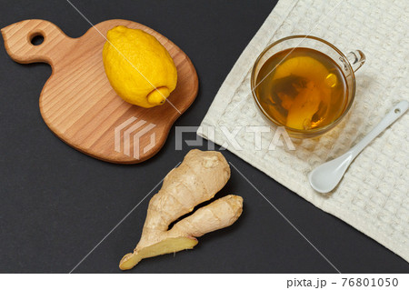 Health remedy foods for cold and flu relief on a black background. 76801050