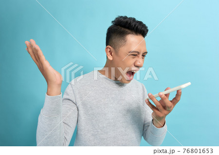 You will have problems man! Angry confused aggressive in bad mood guy shouting threatening in the loudspeaker of his smartphone 76801653