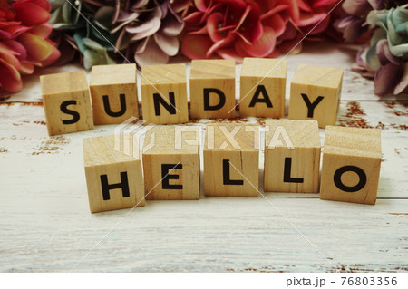 Hello Sunday alphabet letter on wooden background Hello Sunday alphabet letter on wooden background 76803356